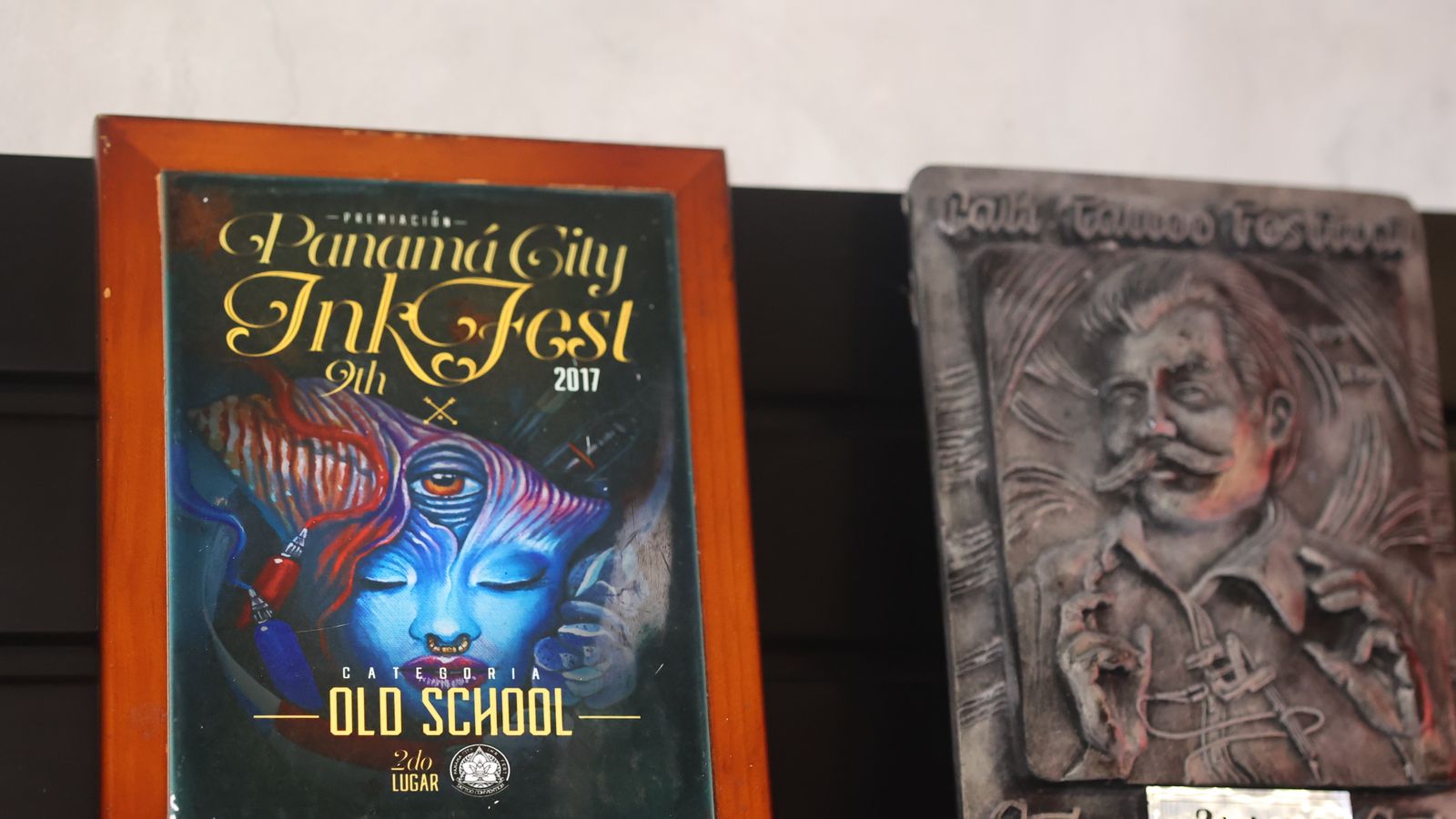 Trophy shelf with the Panama City Ink Fest 2017 Old School plaque and carved stone award