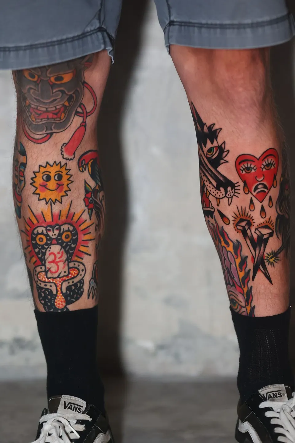 Both legs covered in color American traditional tattoos, large scale work by Ulises Malavé